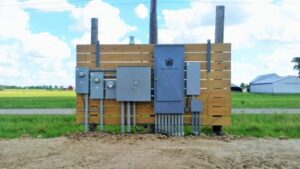 Multiple outdoor electrical meters and panels installed on a wooden structure by All Circuit Electrical LLC in Bryant, IN.