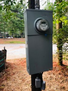 An outdoor electrical meter and main panel installed on a utility pole by McCall Enterprises in Atlanta, GA.