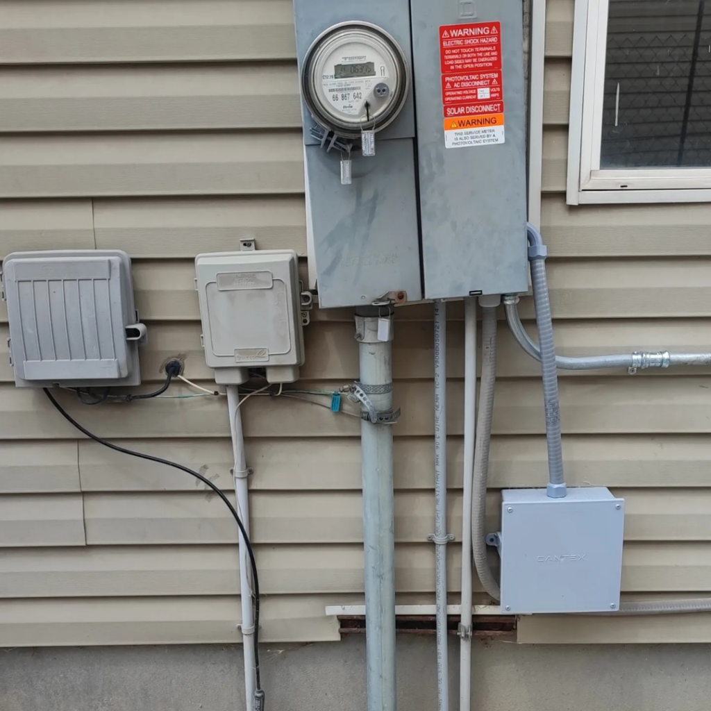 An outdoor electrical meter and service panel with conduits on a house, installed by Lara Electric in Miami, FL.