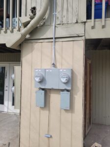 Multiple outdoor electrical meters and conduit installed on the side of a building by Next Level Contracting LLC in Dayton, OH