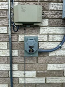 An outdoor electrical outlet and junction box installed on a brick wall by LiveWire Electrical Services, LLC. in Houma, LA.