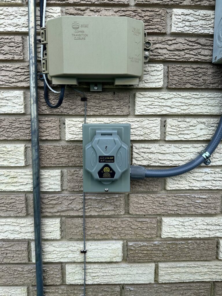 An outdoor electrical outlet and junction box installed on a brick wall by LiveWire Electrical Services, LLC. in Houma, LA.
