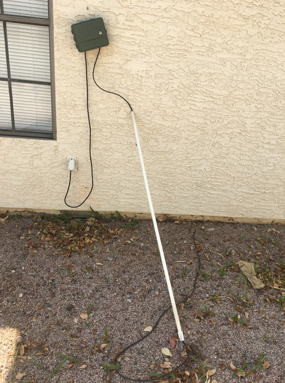 Outdoor electrical outlet and wiring with conduit on the ground by Earth Electric in Mesa, AZ