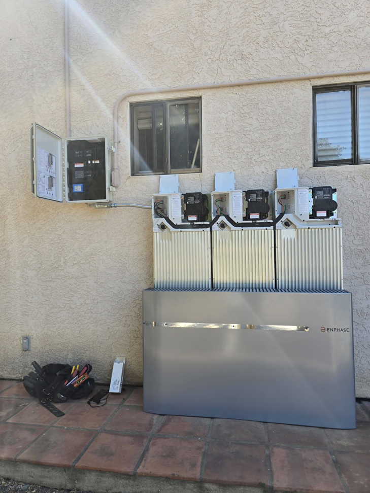 An outdoor electrical panel and Enphase battery storage system installation with tools by Ride the Lightning Electrical Services in El Cajon, CA.