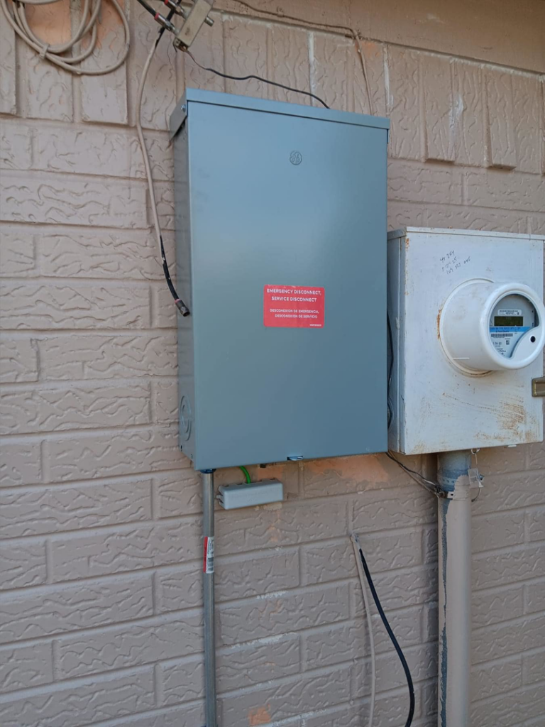 An outdoor electrical panel installed next to an electricity meter by Axon Electric in El Paso, TX.
