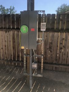 An outdoor electrical panel mounted on a wooden fence post, installed by All 4 You Electrical in Boise, ID.