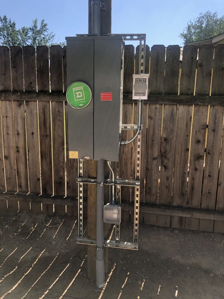 An outdoor electrical panel mounted on a wooden fence post, installed by All 4 You Electrical in Boise, ID.