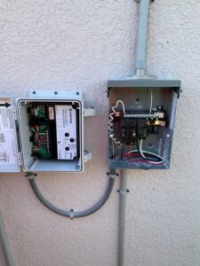 Outdoor electrical panel and control unit installation on a stucco wall by A Solid Connection Electrical Services in Brandon, FL.