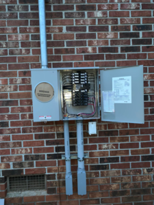 An outdoor electrical panel installation on a brick wall by Alta Electrical LLC in Greer, SC