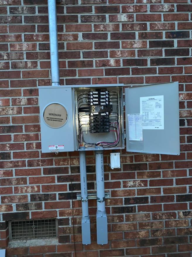 An outdoor electrical panel installation on a brick wall by Alta Electrical LLC in Greer, SC