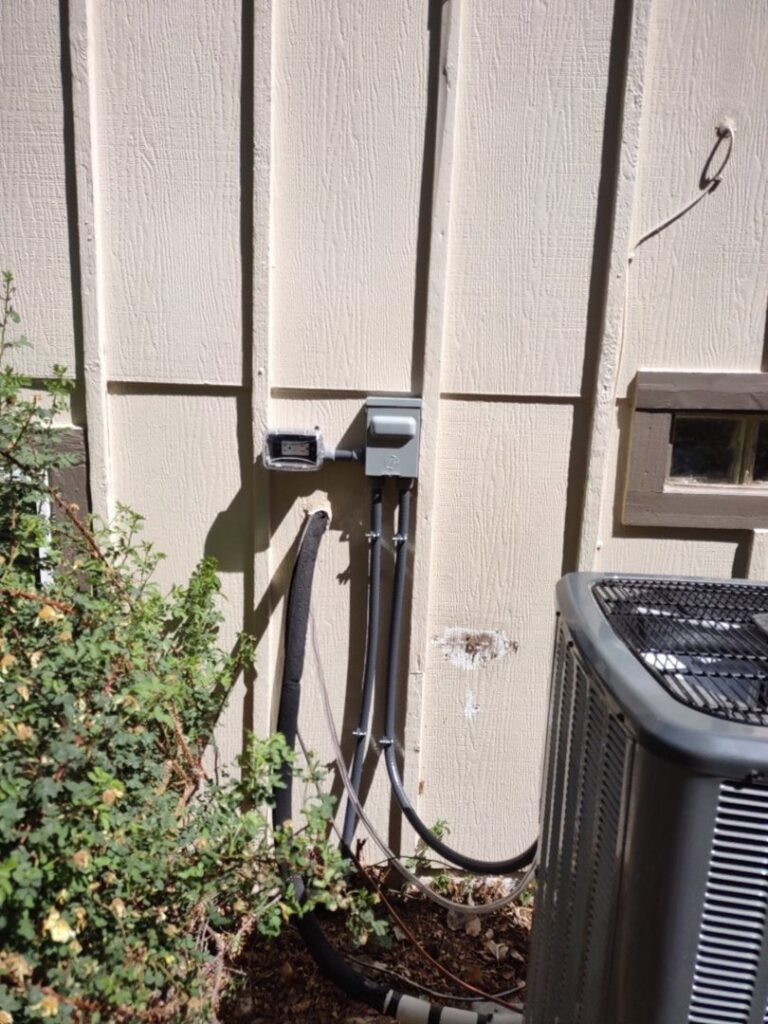 An outdoor electrical panel and conduit professionally installed by Black Bear Electric in Aurora, CO.