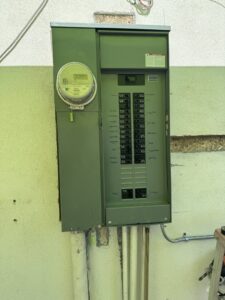 An outdoor electrical panel and meter box installed on a building by MCM Electrical Services LLC in Phoenix, AZ