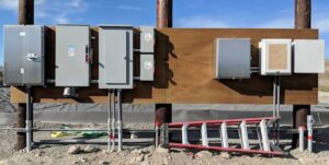 Outdoor electrical panels and conduits installed on a wooden structure, showcasing work by Premier Electric LLC in Palmer, AK.