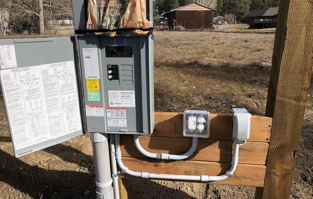 An outdoor electrical panel and meter installed on a wooden post by All 4 You Electrical in Boise, ID.