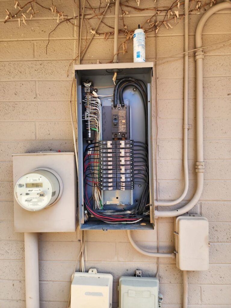 An outdoor electrical panel and meter installation, showing wiring, completed by Johnson Power and Air in Gilbert, AZ.
