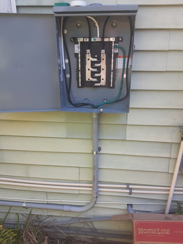 An outdoor electrical panel and conduit installed on the side of a residential building by Positricity in Clearwater, FL.