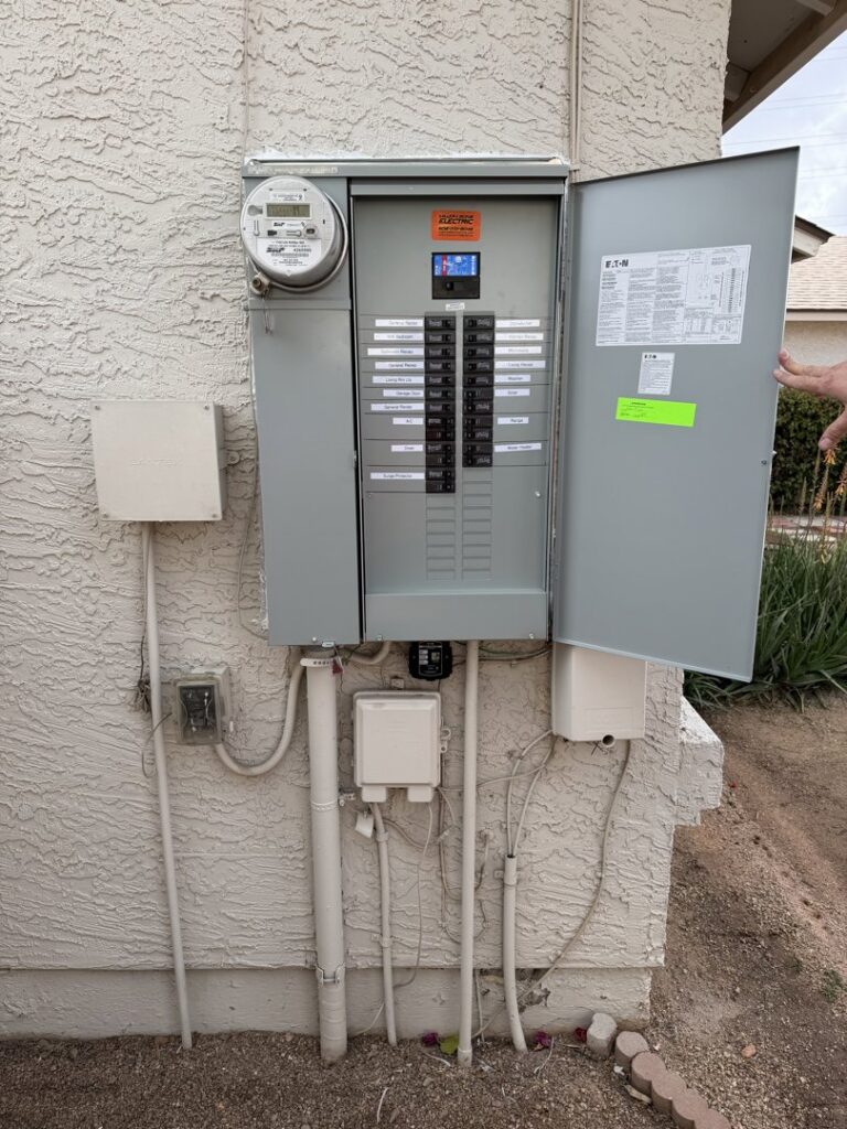 An outdoor electrical panel with its door open, showing wiring and meter, serviced by Miller and Sons Electric in North Myrtle Beach, SC.