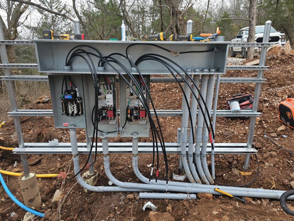 Interior wiring and conduit connections for an outdoor electrical panel by Powered Electrical & Lighting Services LLC in Springfield, MO.
