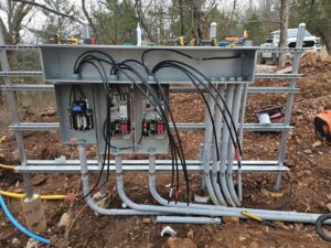 Interior wiring and conduit connections for an outdoor electrical panel by Powered Electrical & Lighting Services LLC in Springfield, MO.
