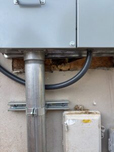 Outdoor electrical panel with conduit and wiring installed by Turn It On Electric in Phoenix, AZ