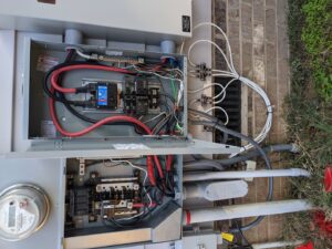 An outdoor electrical pedestal installation on a wooden post by Starnes Electric LLC in Rock Hill, SC.