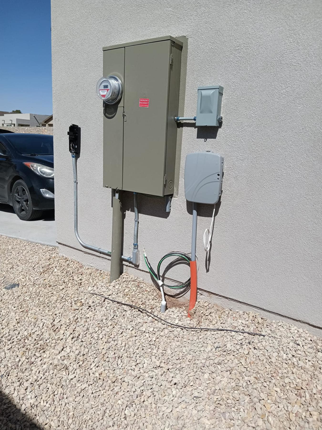 An outdoor electrical service panel and EV charger installation by Axon Electric in El Paso, TX.
