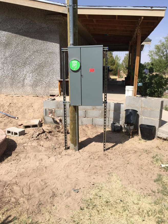An outdoor electrical service panel mounted on a pole by Axon Electric in El Paso, TX.