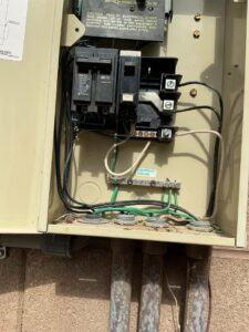An outdoor electrical sub-panel with wiring and breakers, installed by Eco Electric in Las Vegas, NV.