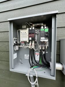An open outdoor electrical transfer switch or main service panel with internal wiring by Babcock Electric & Communications in Lake Charles, LA.