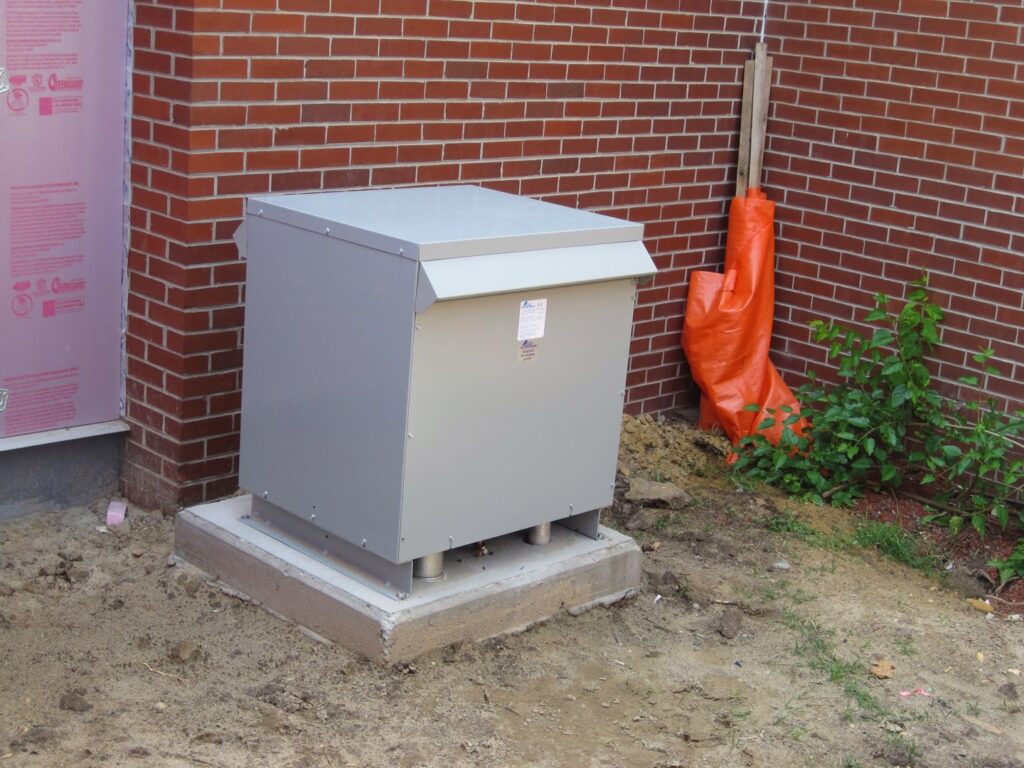 An outdoor electrical transformer or utility box installed on a concrete pad by Argosy Electric, Inc. in Newport News, VA