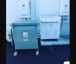 Two large outdoor electrical transformers, indicating commercial or industrial electrical service by BR Electric in Newcastle, OK.