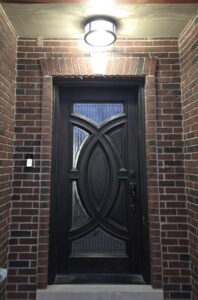 An outdoor light fixture and doorbell system installed above a front door by ILIC Electric in Chicago, IL.