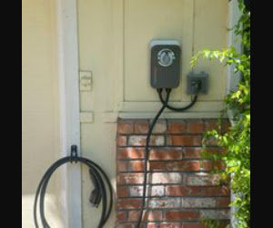 An outdoor electric vehicle charger installation on a home's exterior wall by BR Electric in Newcastle, OK.