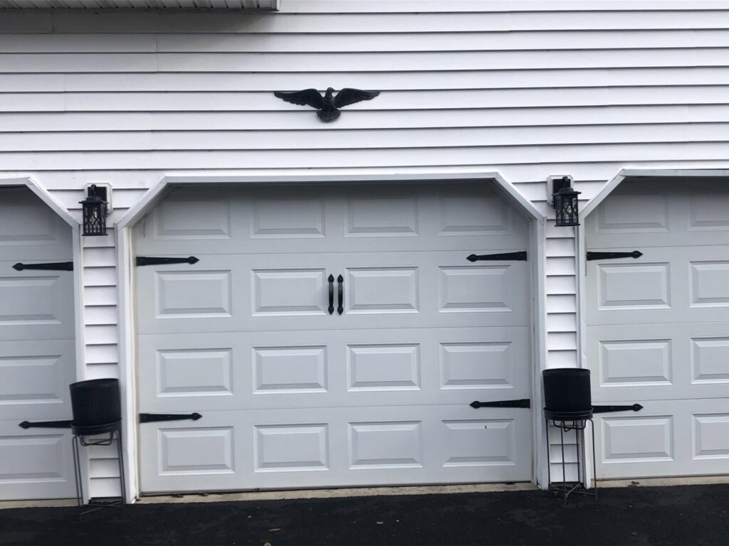 Outdoor light fixtures installed above garage doors by The Dorky Electrician, LLC in Coplay, PA