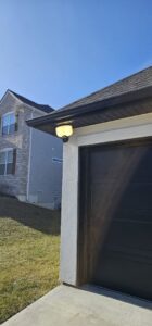 A newly installed outdoor light fixture on the corner of a garage by Midway Electric in Columbia, MO