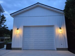 Exterior of a garage with new outdoor wall sconce lighting installed by Be Bright Electric in Erie, PA.