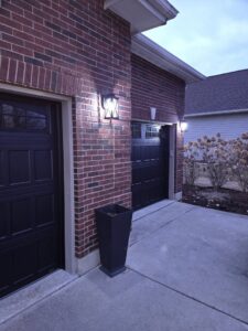 Outdoor wall sconces illuminating garage doors, installed by ILIC Electric in Chicago, IL.
