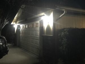 Bright outdoor lighting installed on a garage exterior at night by Olectric in Reno, NV.