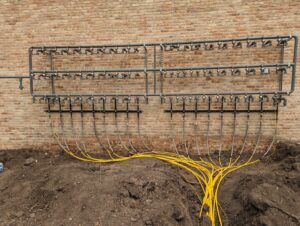 An outdoor geothermal or hydronic piping system installed by Advantage Mechanical, Inc. in Appleton, WI.