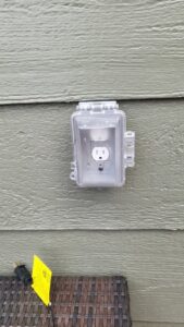 An outdoor GFCI outlet with a weather-resistant cover installed by Swartz Electric in Colorado Springs, CO.