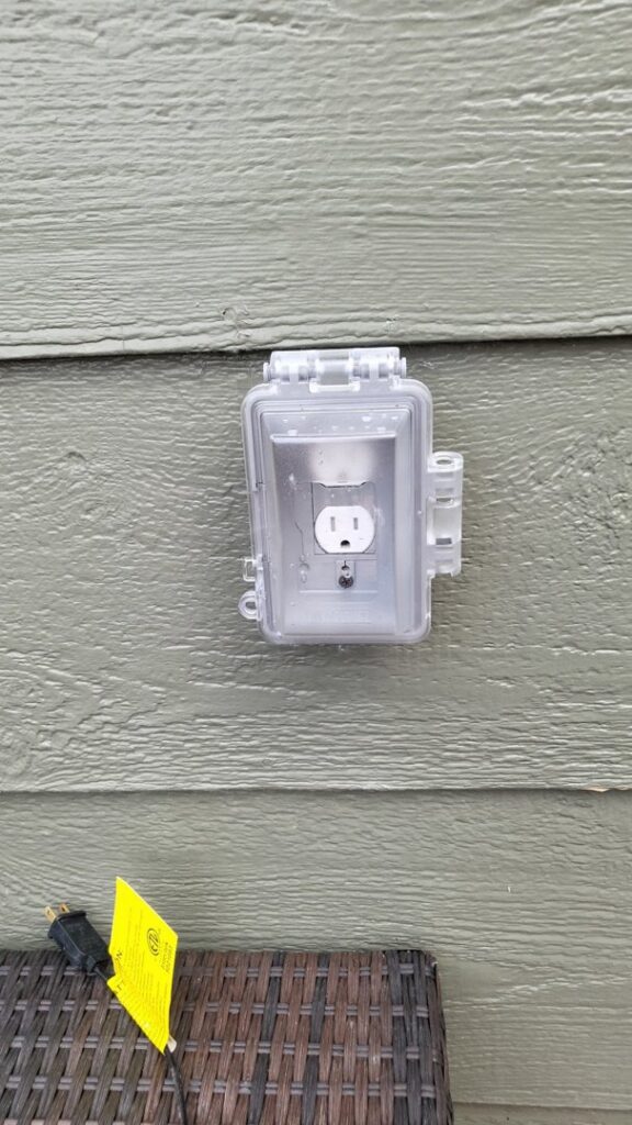 An outdoor GFCI outlet with a weather-resistant cover installed by Swartz Electric in Colorado Springs, CO.