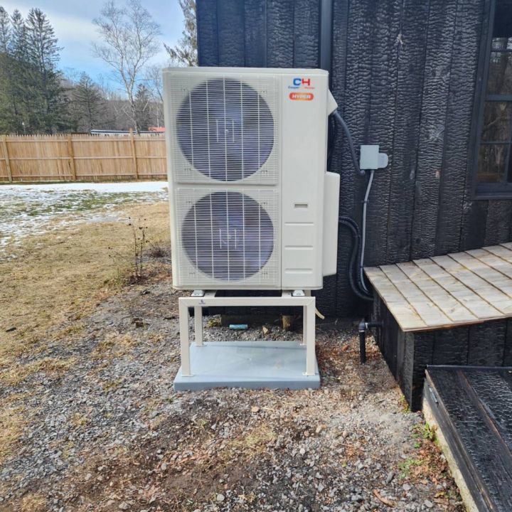 An outdoor heat pump or mini-split condenser unit installed by All The Way Heating & Cooling in Middleburgh, NY