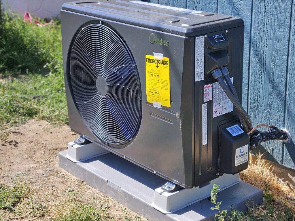 An outdoor heat pump or air conditioning condenser unit installed by ABC Mechanical Inc in Lawrenceville, GA.