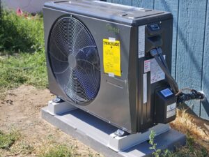An outdoor heat pump or air conditioning condenser unit installed by ABC Mechanical Inc in Lawrenceville, GA.