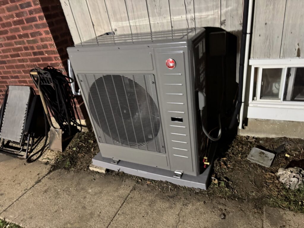 An outdoor heat pump or mini-split condenser unit installed by Etek Refrigeration Heating and Cooling, Inc. in Chicago, IL.