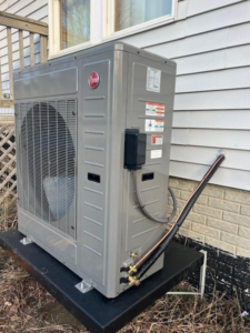 An outdoor heat pump unit installed next to a home by Extreme Heating & Cooling in Beaver Dam, KY