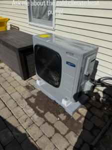 An outdoor heat pump unit installed next to a house by Lighthouse HVAC, LLC in Edgewater, MD.