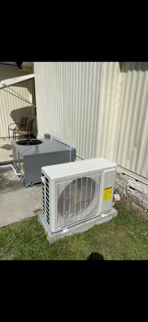 An outdoor HVAC condenser and a mini-split unit installed by Uplifting Air, LLC in San Antonio, FL.