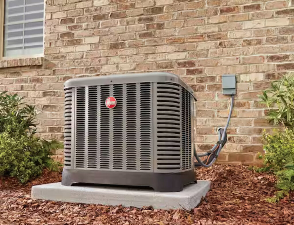 An outdoor HVAC condenser unit installed next to a brick residential building by Anderson Mechanical Inc. in Pascagoula, MS