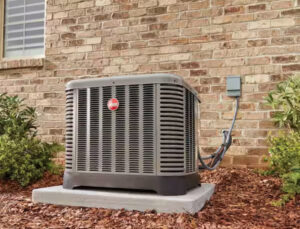 An outdoor HVAC condenser unit installed next to a brick residential building by Anderson Mechanical Inc. in Pascagoula, MS